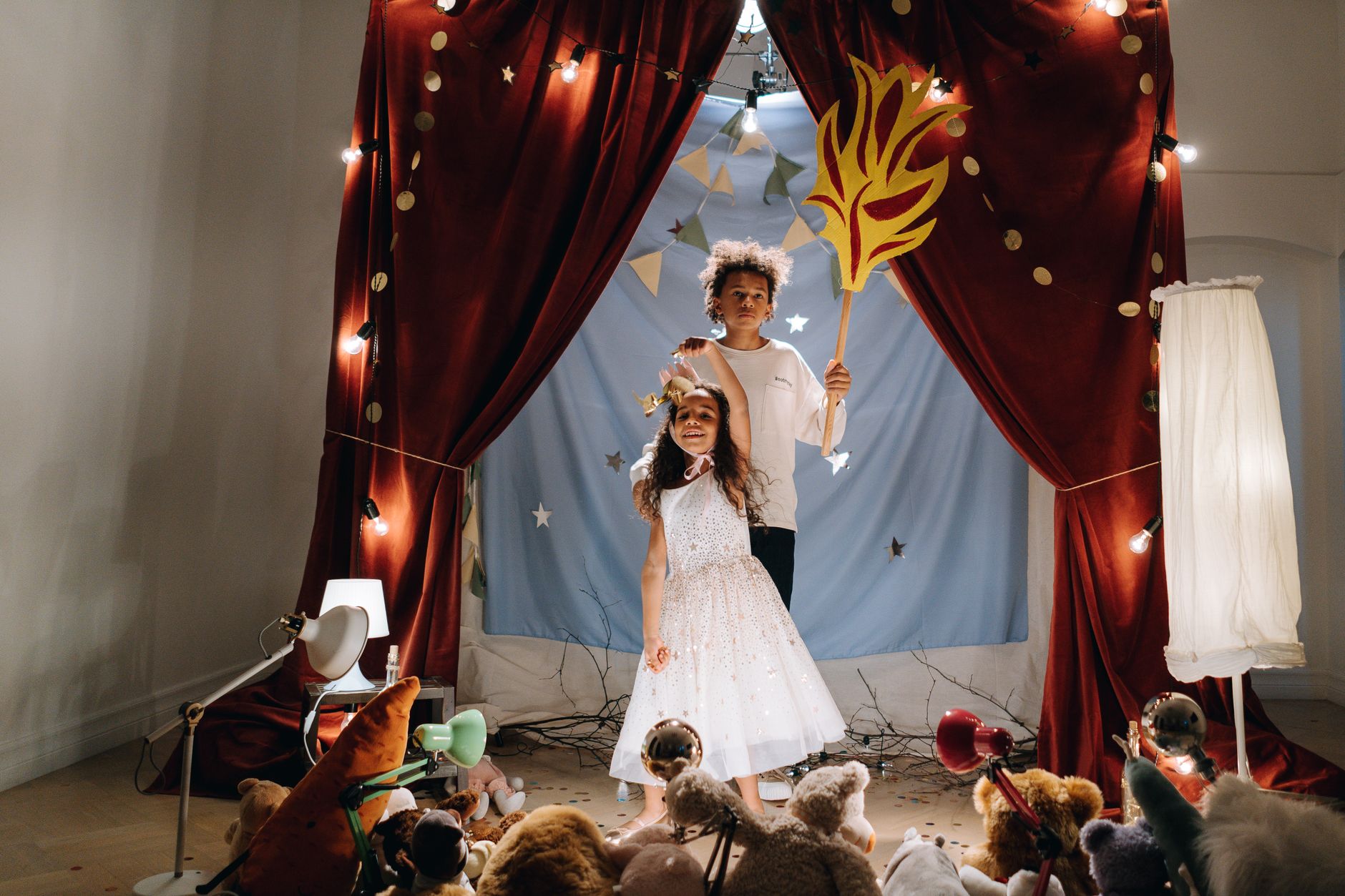 10 Simple Activities to Boost Creativity in Preschool Kids 3 Two children in a fantasy-themed play with costumes and props on a decorated stage.