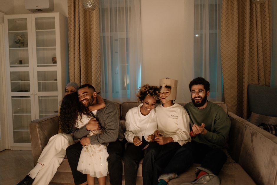 Happy family relaxing in a living room with premium engineered hardwood flooring Happy family relaxing in a living room with premium engineered hardwood flooring