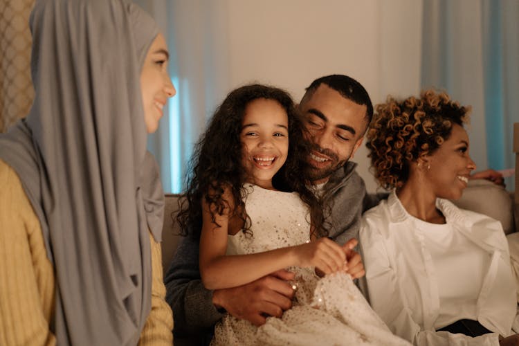 A Family Sitting On The Couch