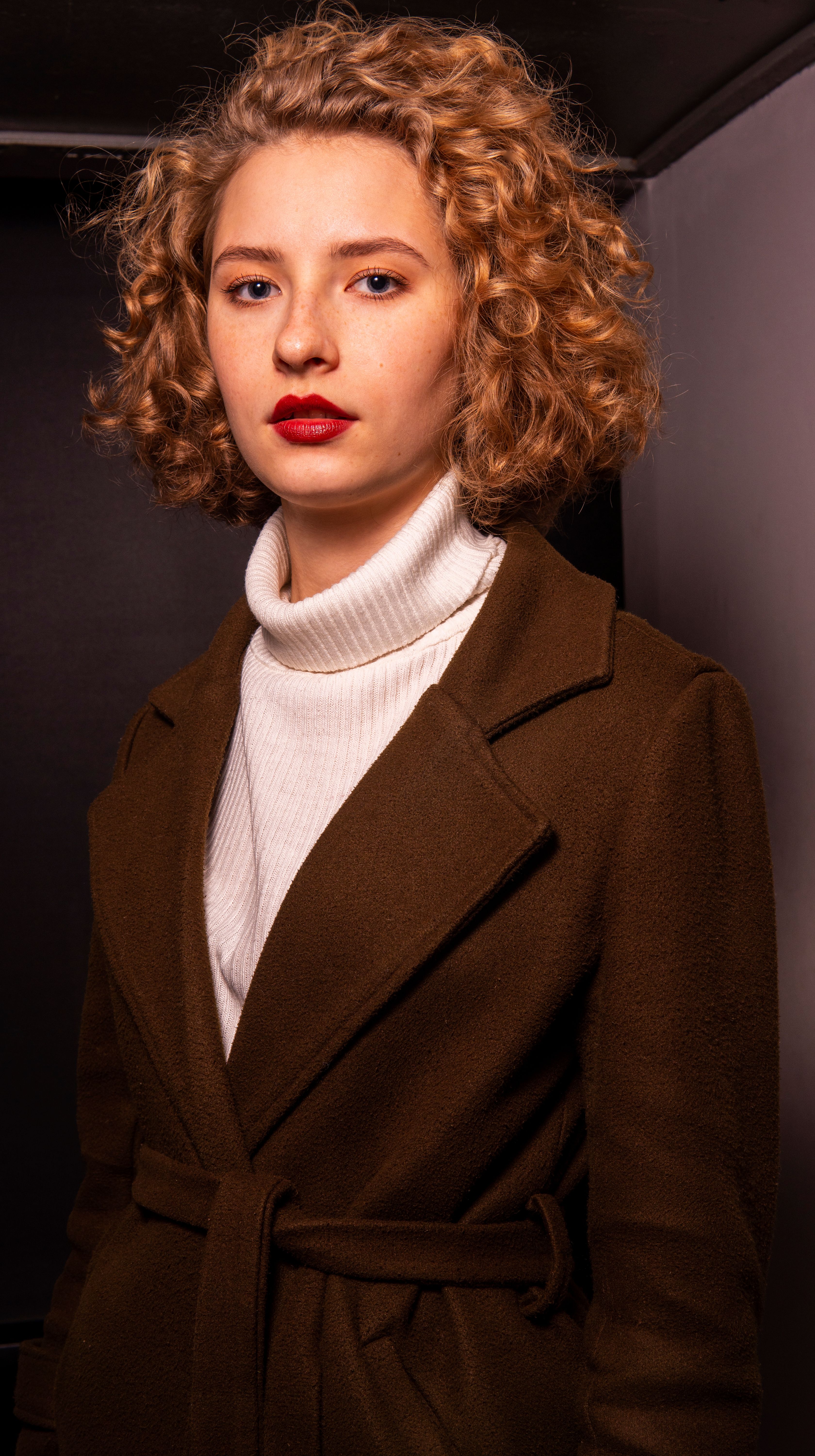 A Portrait of a Woman in a Brown Coat · Free Stock Photo