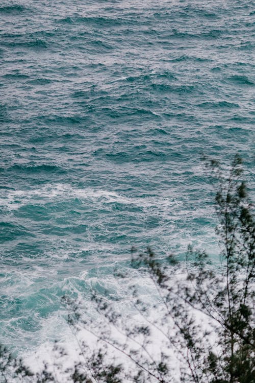 Stormy blue ocean with foamy waves on rainy day