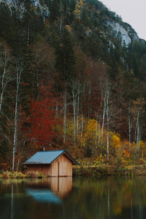 Wooden house in lake near mountain