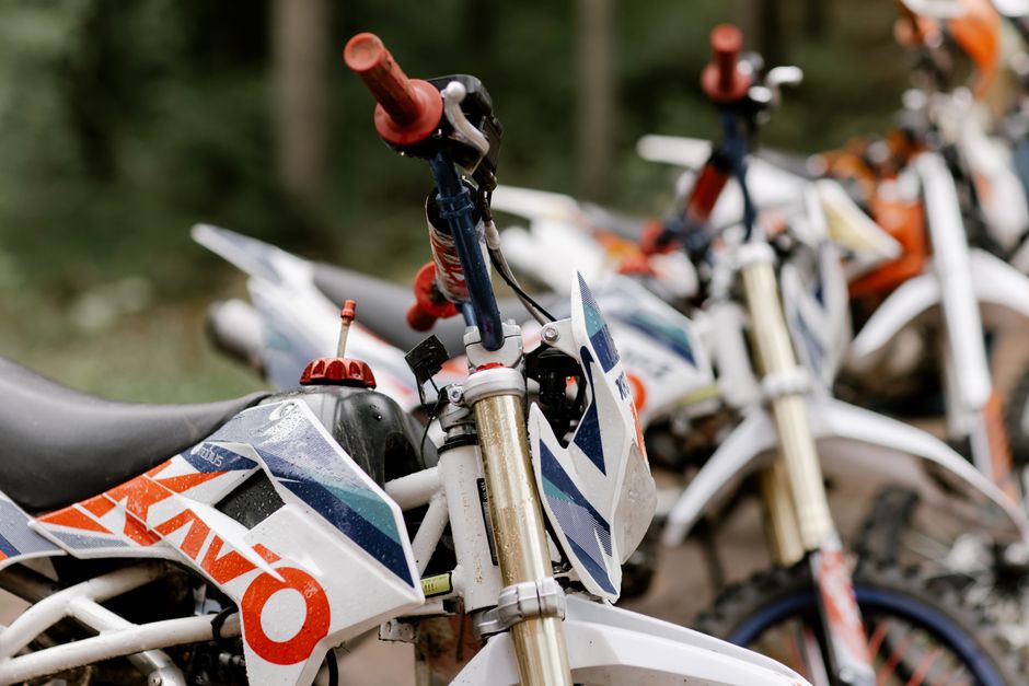 Detailed view of parked dirt bikes ready for motocross adventure outdoors.
