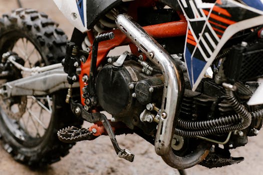Detailed view of a dirt bike's engine and components, highlighting its rugged design.