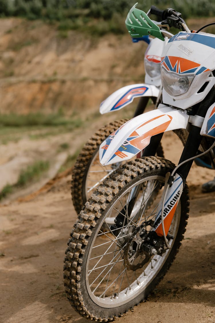 Dirt Bikes Parked On Dirt Road