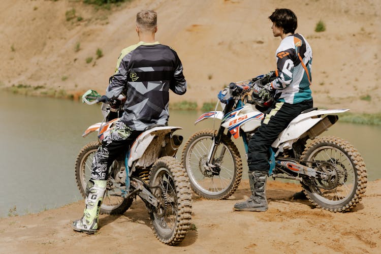 Men Riding Dirt Bikes On Brown Dirt Road