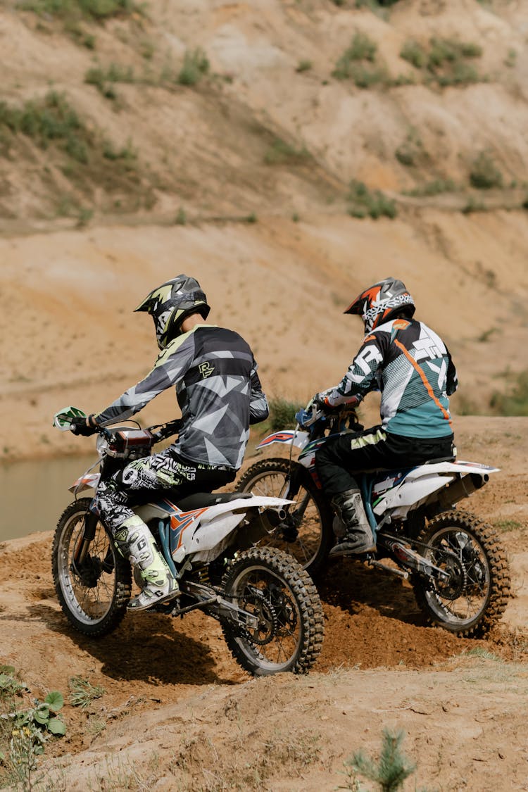 Persons Wearing Helmets Riding Dirt Bikes