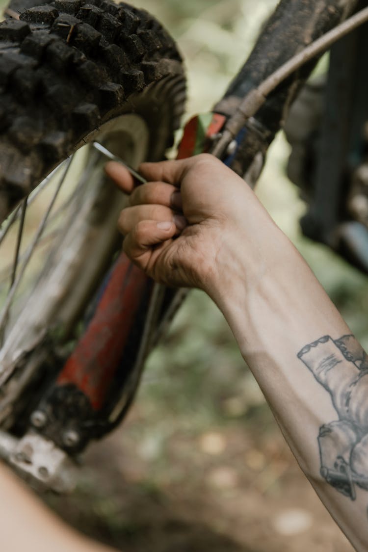 Person Checking A Motorcycle Tire