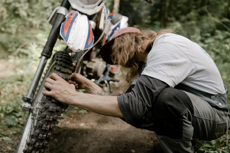 Rider Checking His Tire