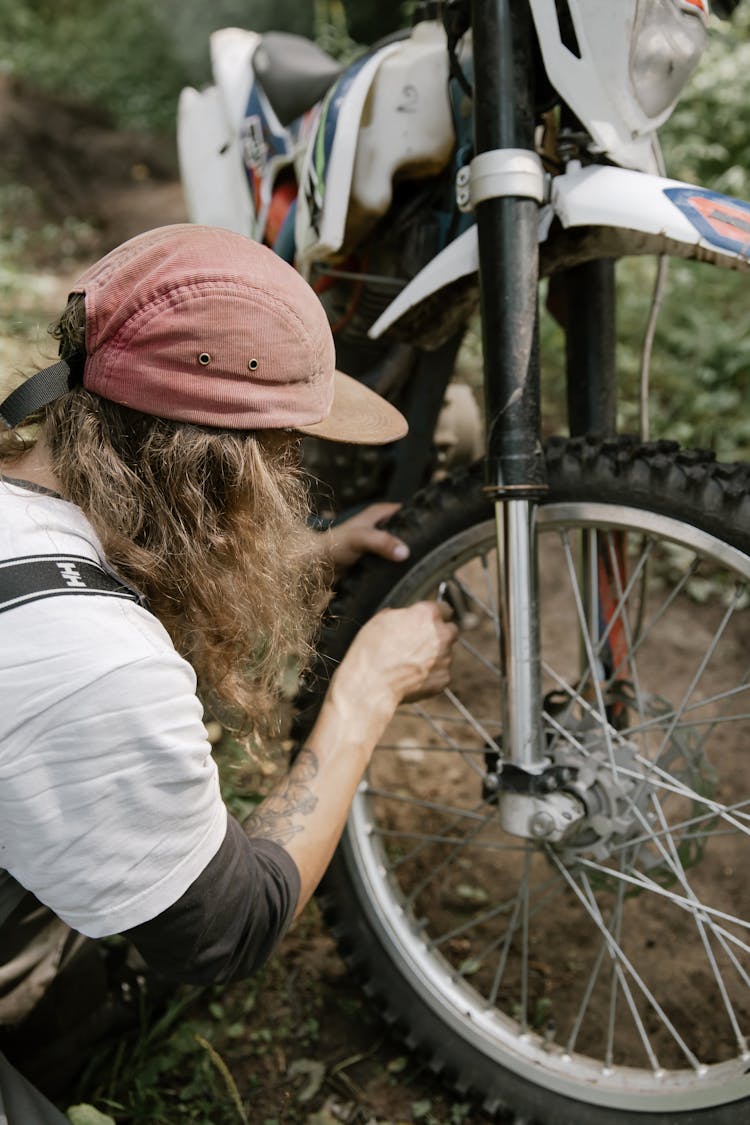 Person Repairing A Motorbike Tire 