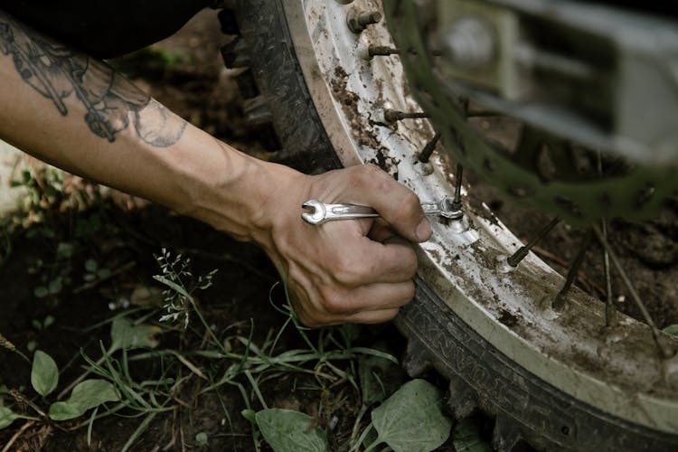 Person Holding A Silver Wrench