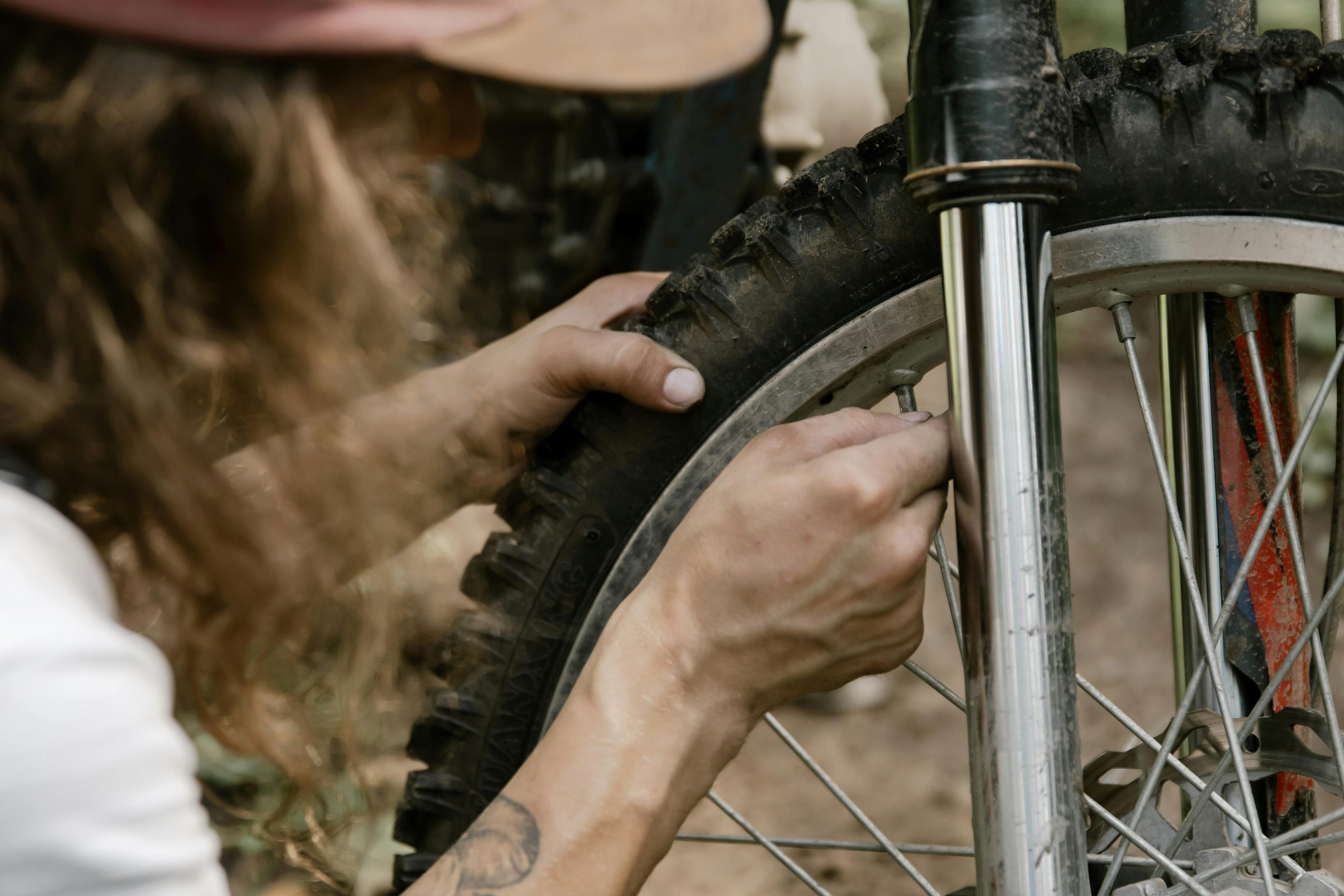 person holding black motorbike tire