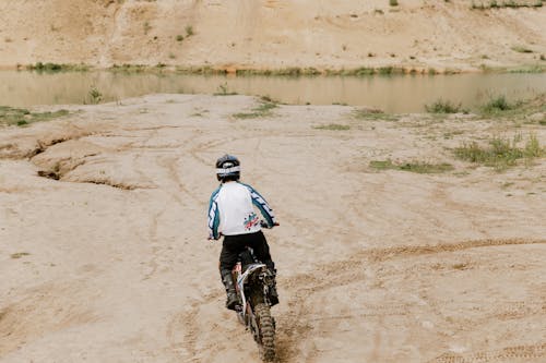 Person Riding a Motorbike on Dirt Road