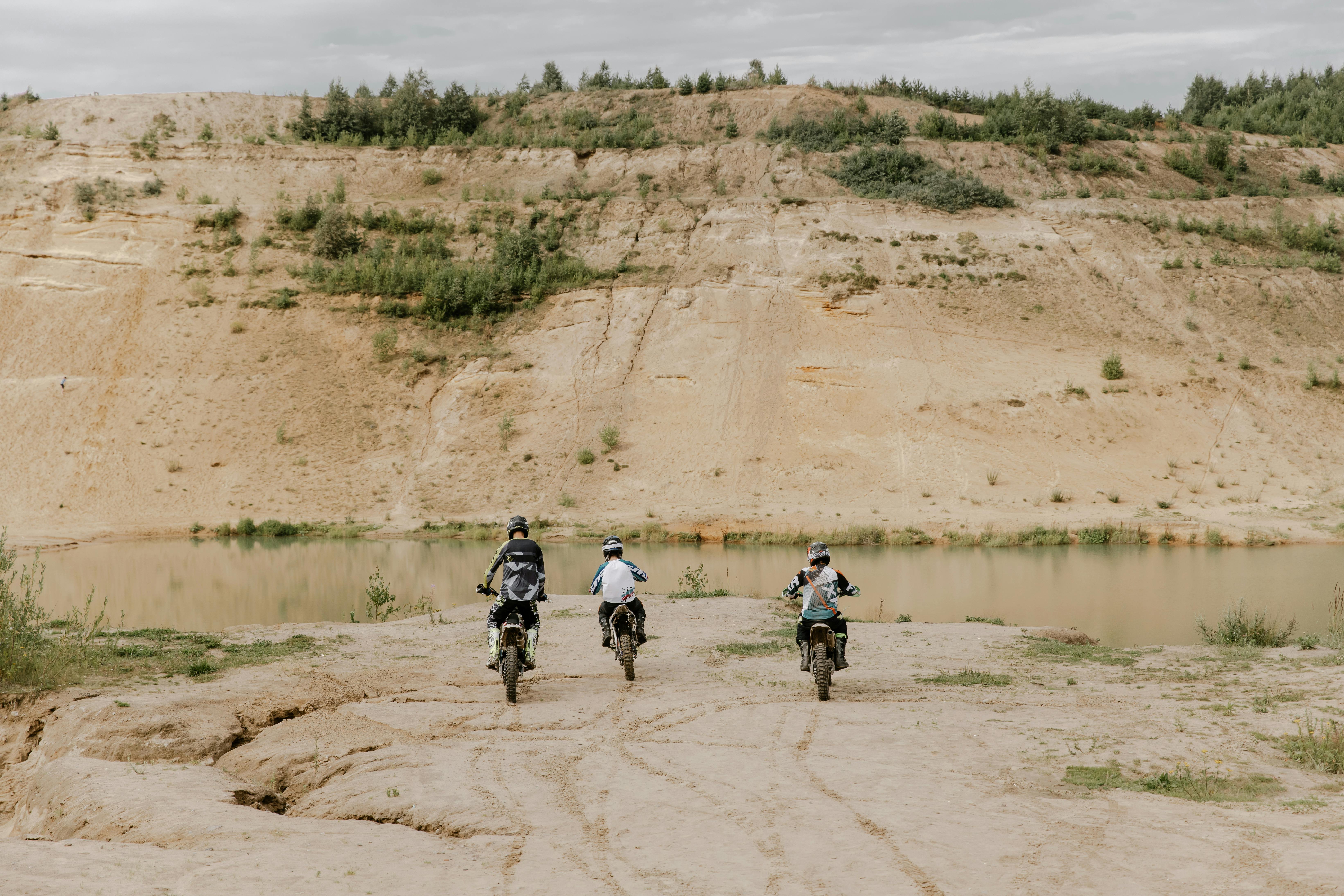 Riders riding their Motorbikes on an Arid Land · Free Stock Photo
