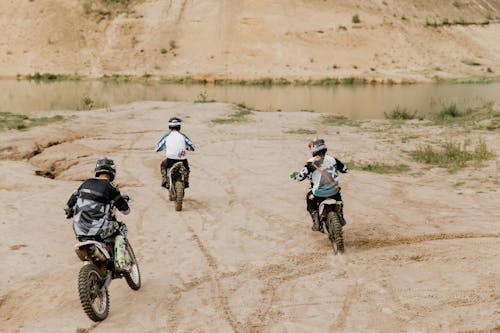 Free Three People Riding on Dirt Bikes Stock Photo