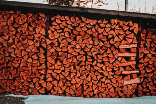 Free A large stack of chopped firewood stored outdoors, ready for use. Stock Photo