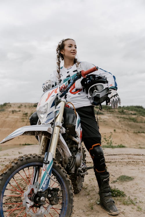 Woman in White Long Sleeves Riding a Motorcycle