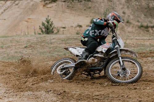 Free Person Riding on Motocross Dirt Bike Stock Photo