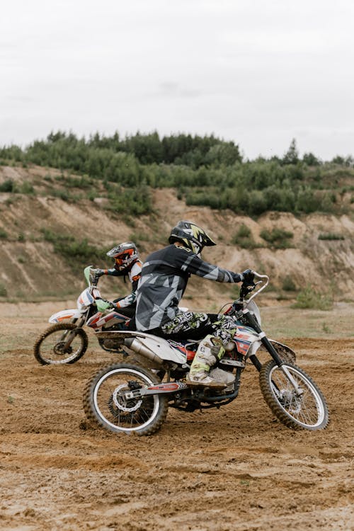 Two People Riding on Motocross Dirt Bikes