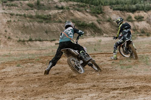 A Two Men Riding a Motocross