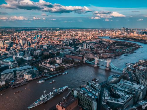 Free Stunning aerial view of Tower Bridge and the River Thames in London at sunset. Iconic urban landscape. Stock Photo