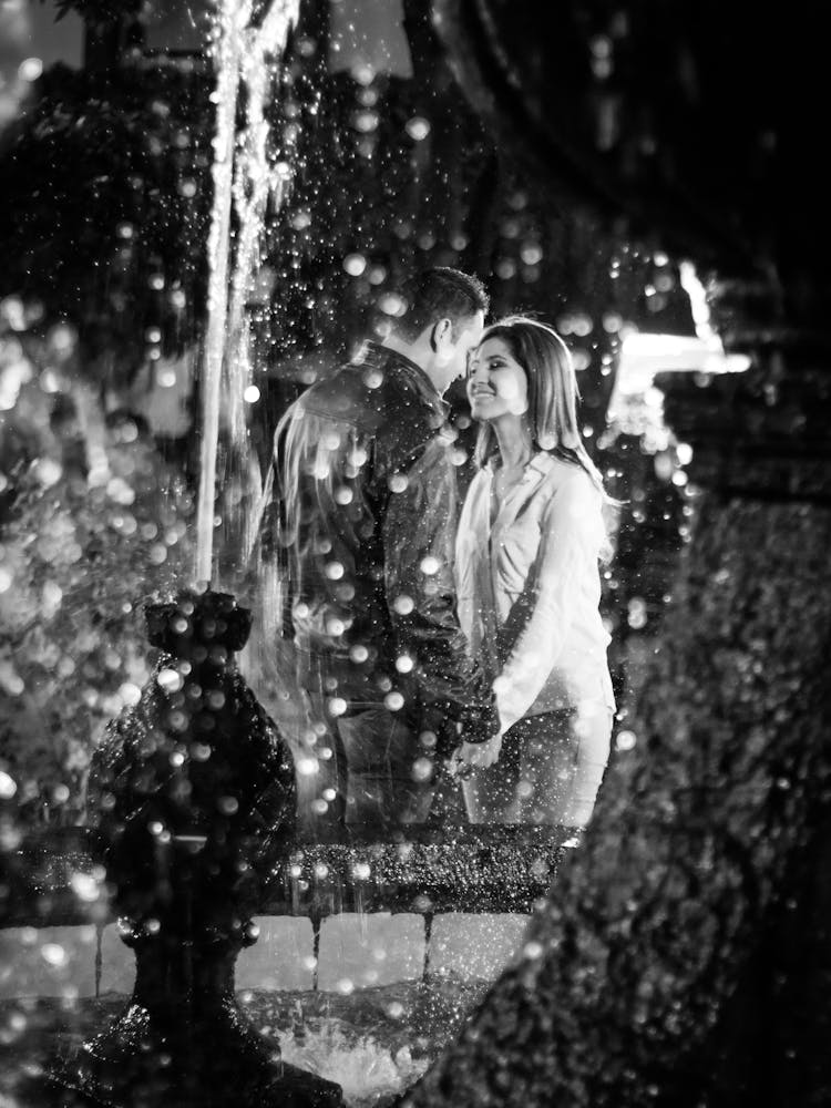 Black And White Portrait Of Couple Behind Fountain