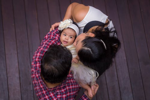 Free Parents Kissing Their Daughter Stock Photo