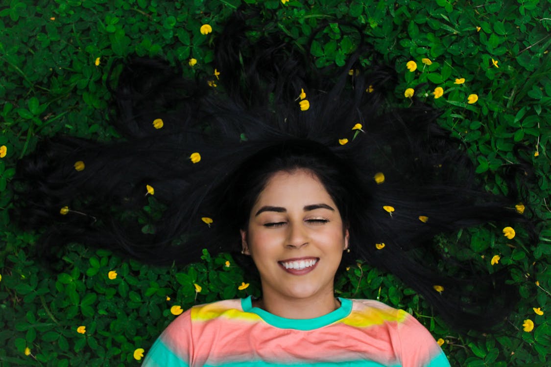 Free A Woman Lying Down on the Grass Stock Photo