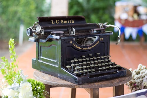 Retro Typewriter Machine on Wooden Table Outdoors