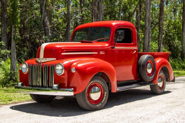 Classic red Ford truck in forest