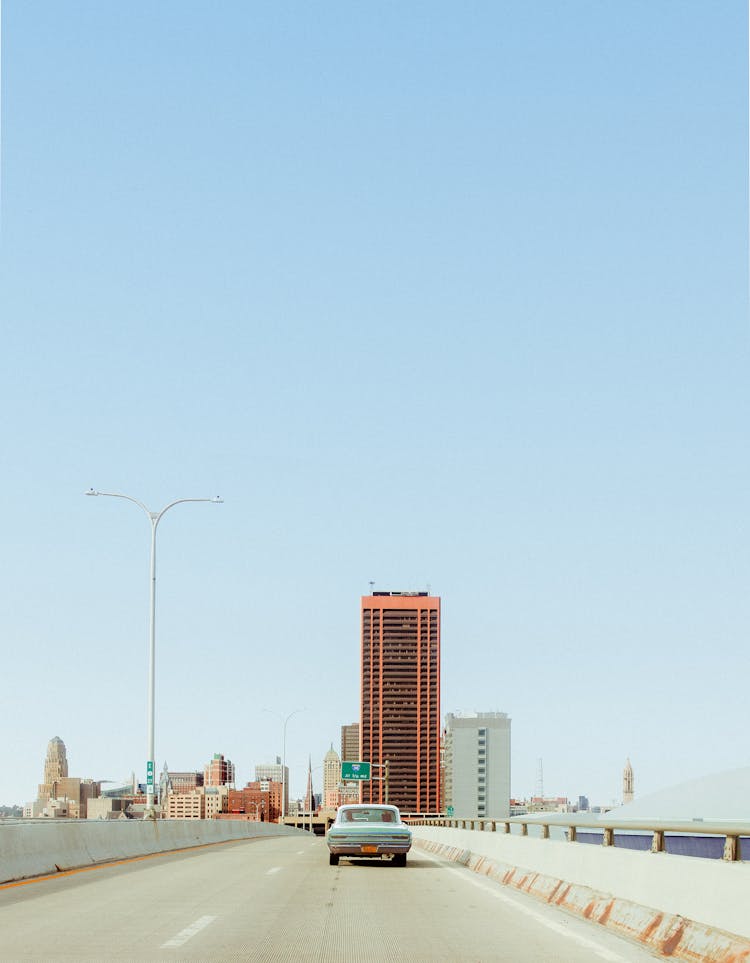 A Car Driving A Concrete Bridge 