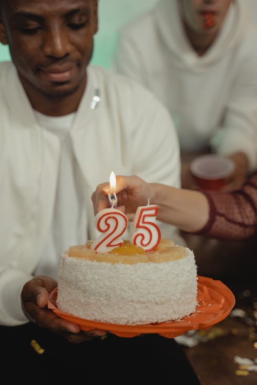 A Man in White Long Sleeves Holding a Birthday Cake
