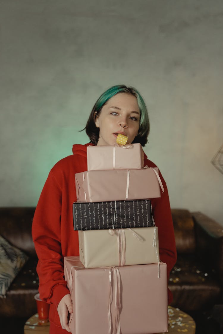 A Woman Carrying A Stack Of Presents While Blowing A Whistle