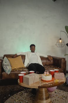 A man celebrates his 25th birthday at home with decorations and gifts, embracing the quarantine life.