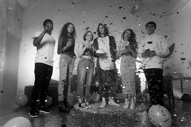 Grayscale Photo Of People At A Birthday Party