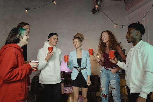 Free A Group of Friends Smiling while Holding a Drinks Stock Photo