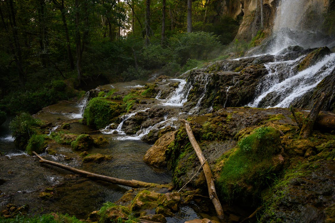 Waterfall Flowing Through Covered with Moss Rocks 