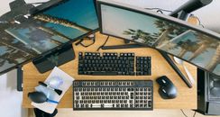 From above of desktop with multi monitors and keyboard with remove keycaps for cleaning