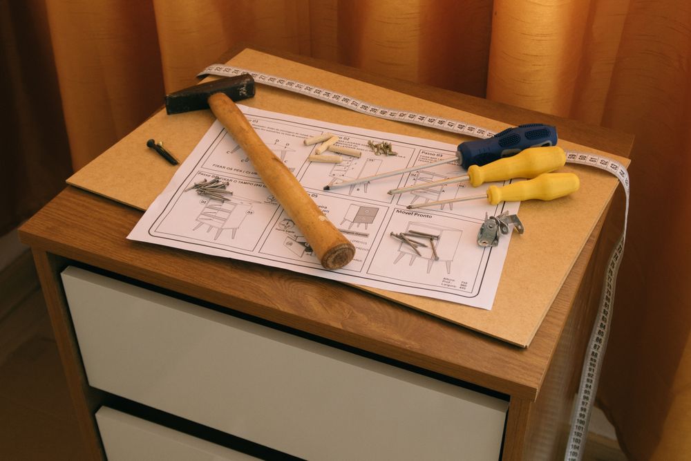 Tools and instructions laid out for flat-pack furniture assembly
