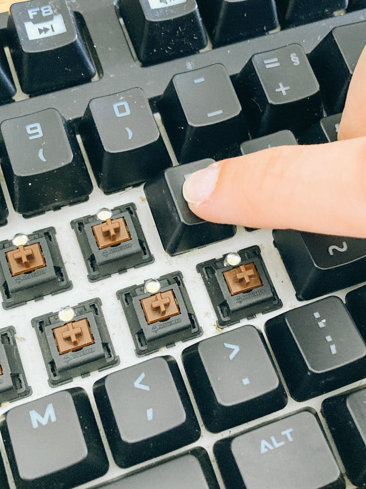 Person Pushing Keycaps After Cleaning Keypad