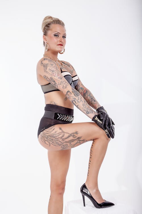 Free A Tattooed Woman Wearing Underwear and Black Gloves Stock Photo
