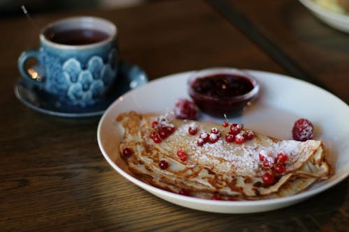 Flatbread on White Plate Near Blue Mug