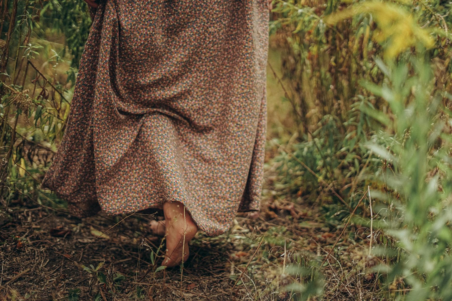 Woman in long dress walking along forest · Free Stock Photo