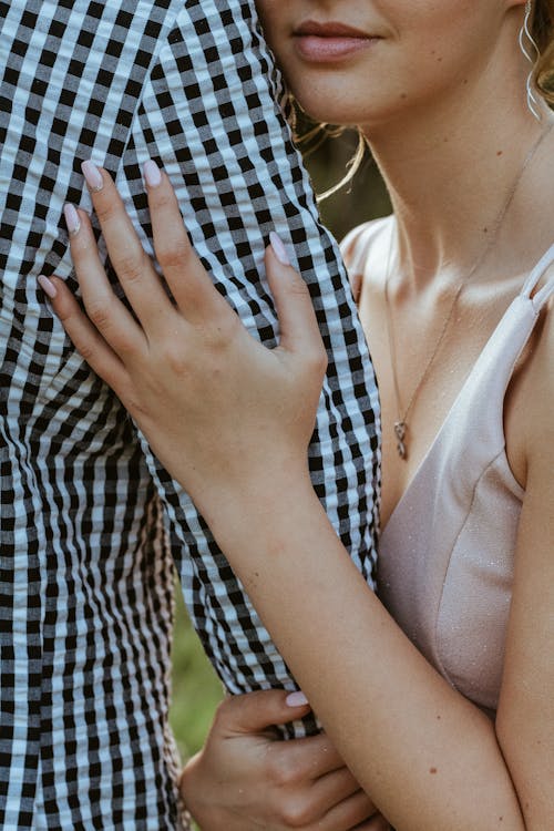 Crop couple hugging in nature