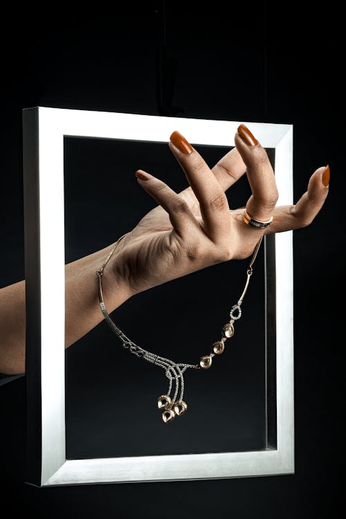 Free Hand Holding a Necklace Stock Photo