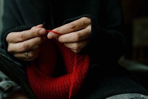 Free Close-Up Photo of a Person's Hands Knitting Red Yarn Stock Photo
