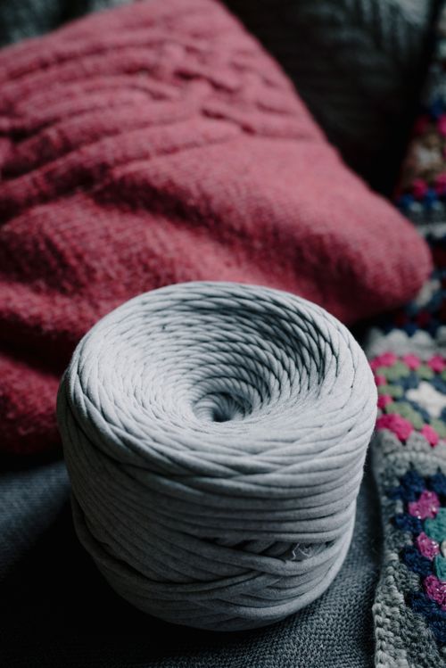 Free Soft yarn coil on textured knit fabrics creating a warm, cozy atmosphere. Stock Photo