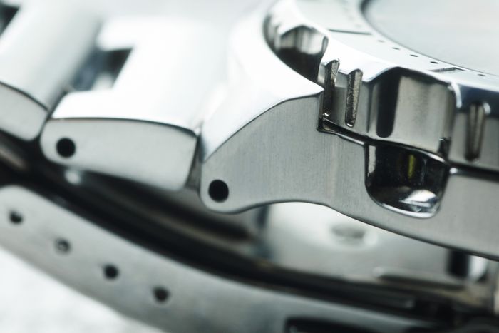 Close detail of a brushed steel bracelet clasp, photo by Yury Kim on Pexels