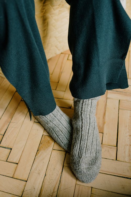 Free Gray Socks on Wooden Floor Stock Photo