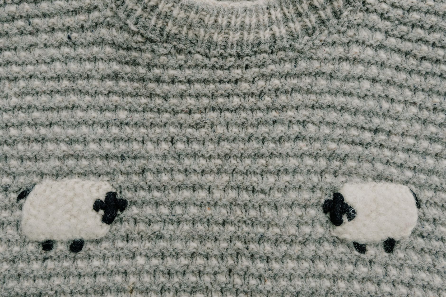 merino sweater shown before washing and after felting shrinkage with visible size difference